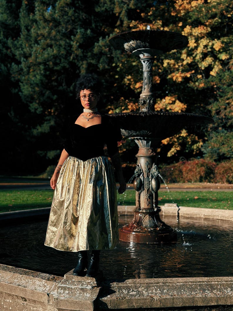 Black velvet bodice and metallic gold skirt detail